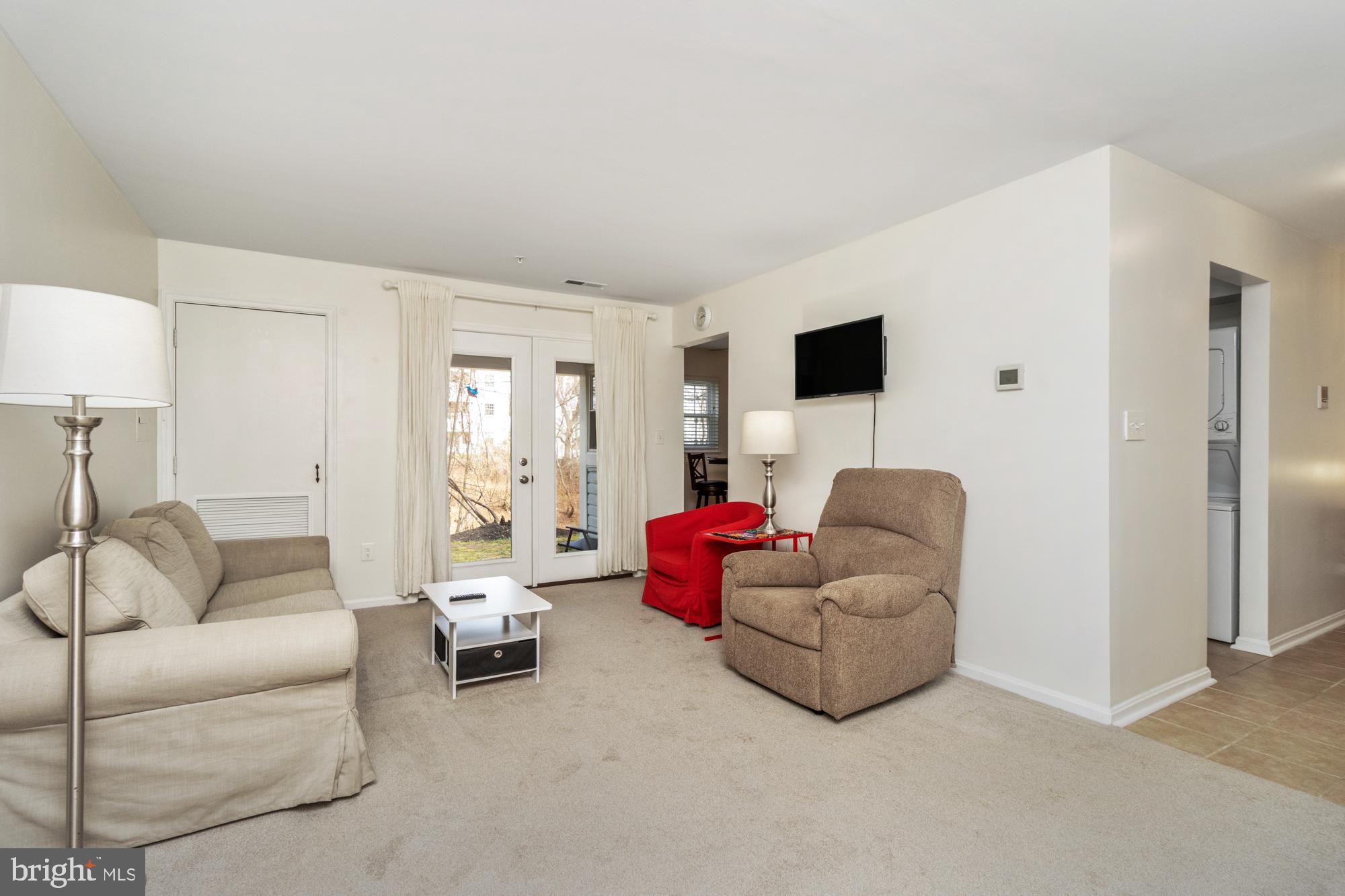 8489 Falls Run Road, Unit B Ellicott City, MD 21043 - Photo 17 of 41 a living room with furniture and a flat screen tv