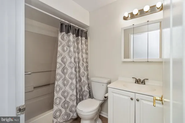 a white toilet sitting next to a bathroom sink