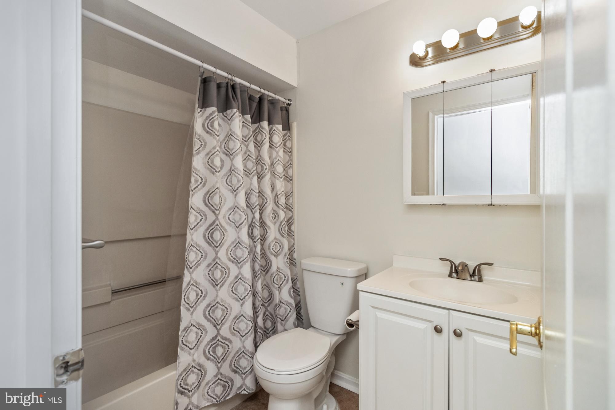8489 Falls Run Road, Unit B Ellicott City, MD 21043 - Photo 20 of 41 a white toilet sitting next to a bathroom sink