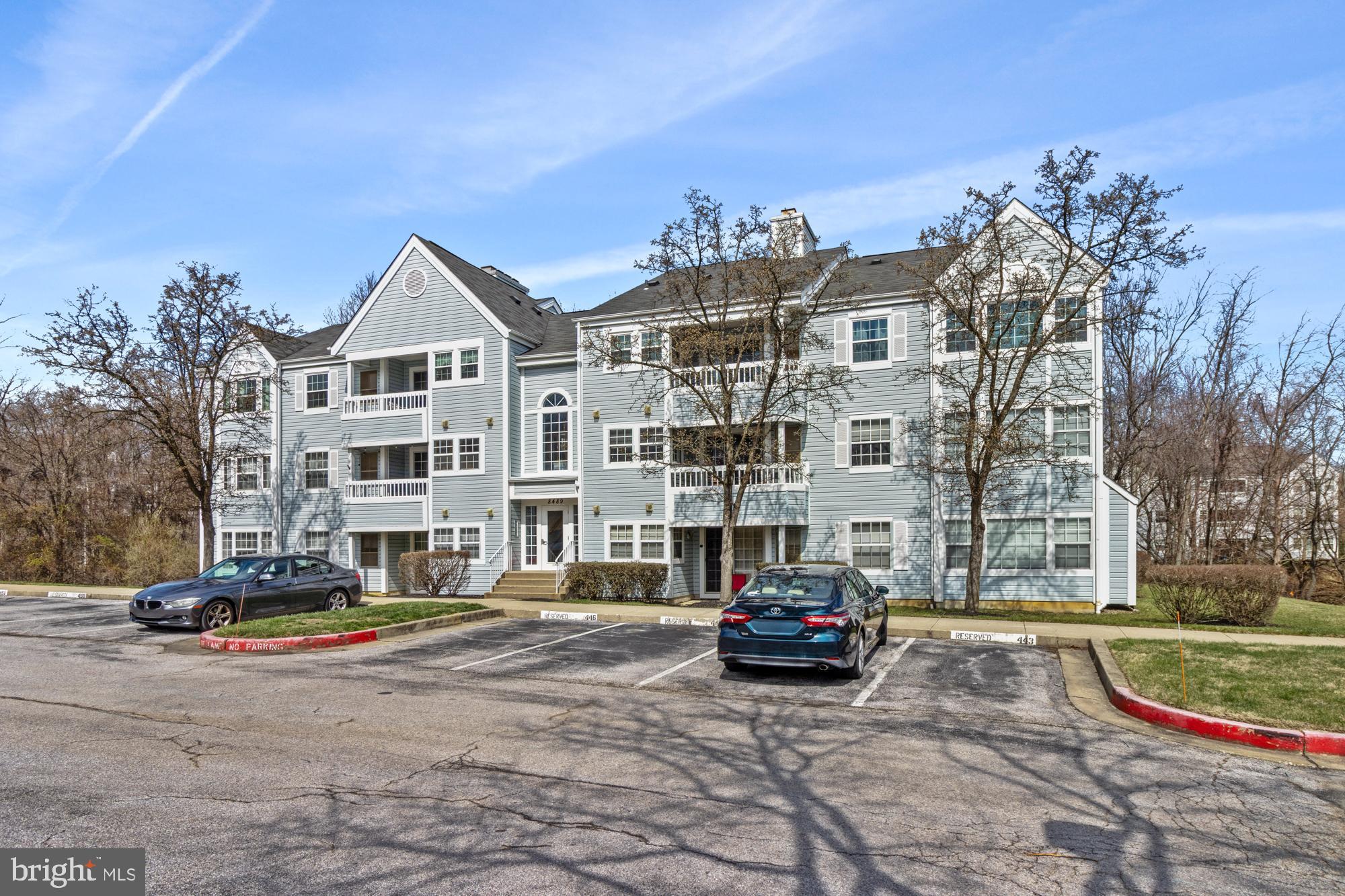 8489 Falls Run Road, Unit B Ellicott City, MD 21043 - Photo 2 of 41 a building with trees in front of it