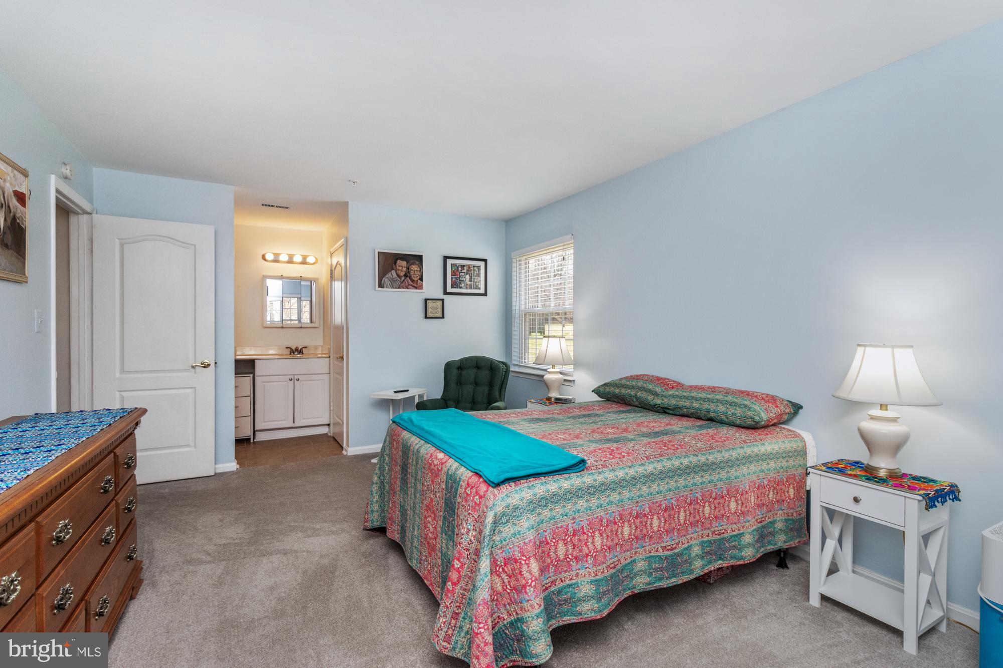 8489 Falls Run Road, Unit B Ellicott City, MD 21043 - Photo 23 of 41 a bedroom with a bed and a lamp on table