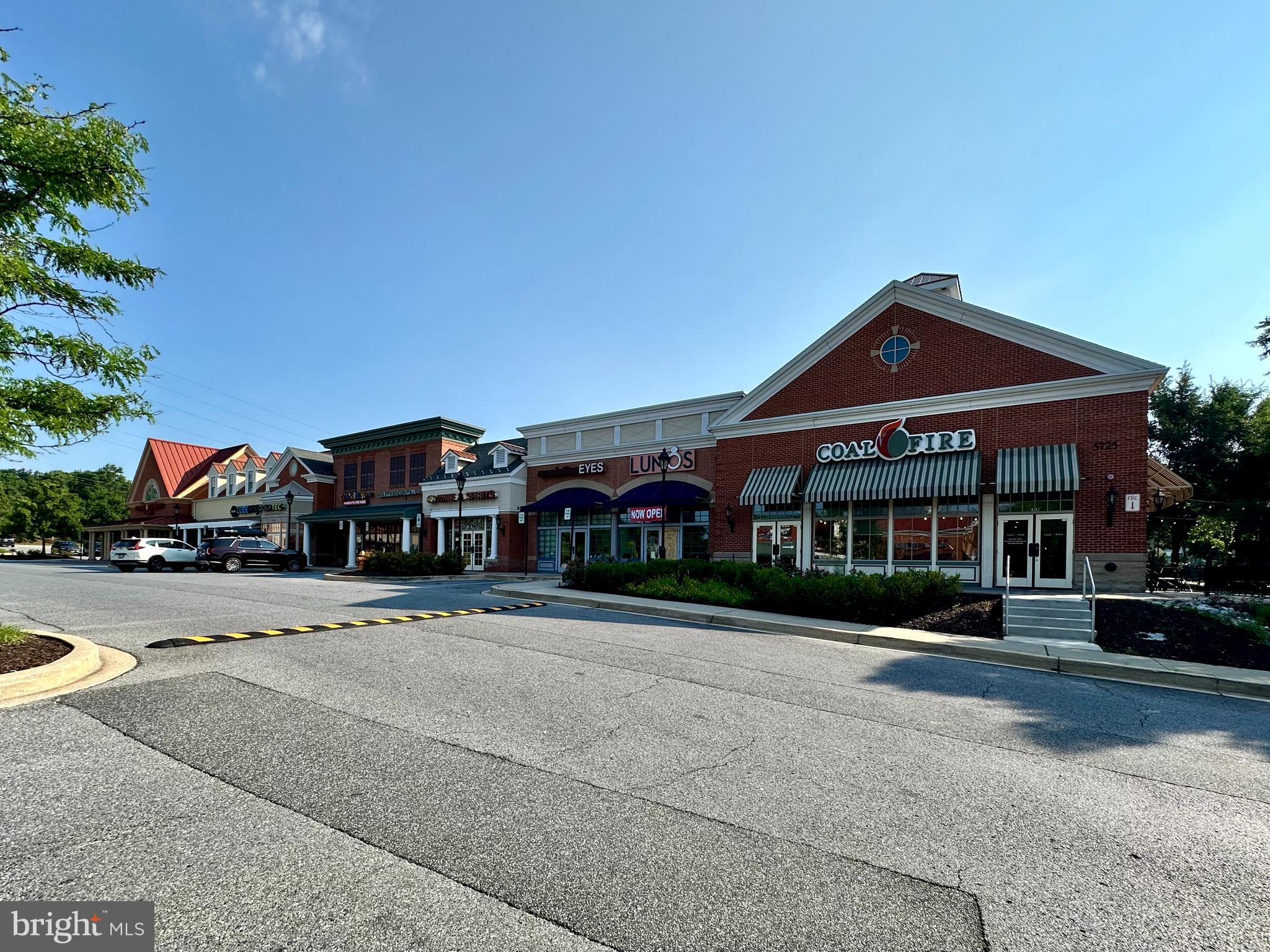 8489 Falls Run Road, Unit B Ellicott City, MD 21043 - Photo 34 of 41 a front view of a building with a garden and trees