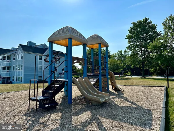 a view of a park with swings and slides