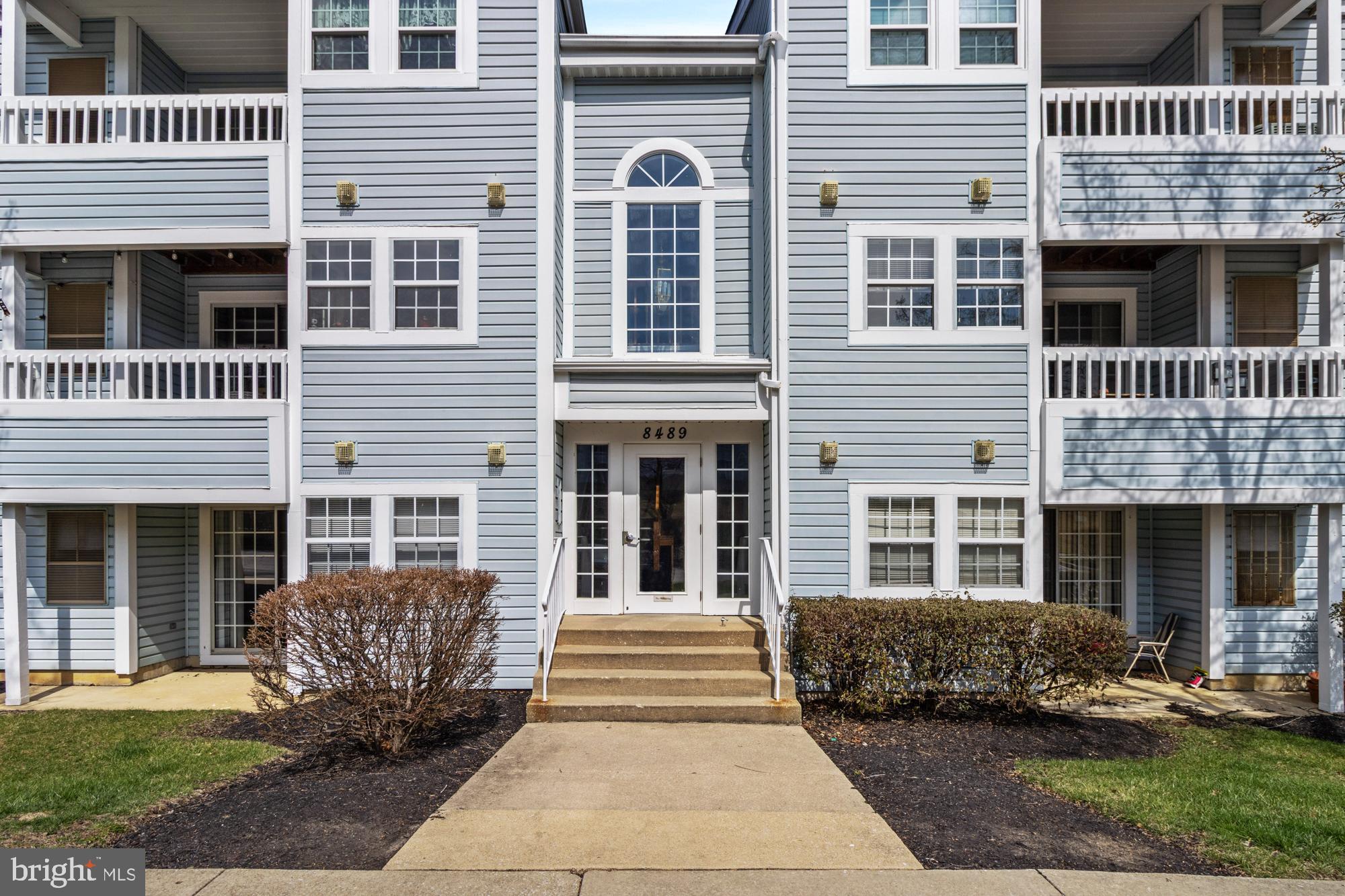 8489 Falls Run Road, Unit B Ellicott City, MD 21043 - Photo 4 of 41 a front view of a house with a yard