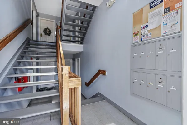 a view of staircase with white walls and a window