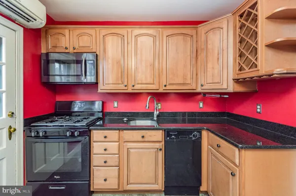 a kitchen with stainless steel appliances granite countertop a stove and a microwave
