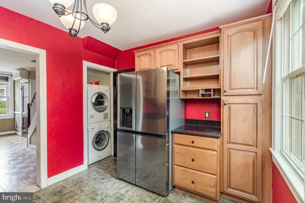 a kitchen with stainless steel appliances granite countertop a refrigerator and a stove top oven