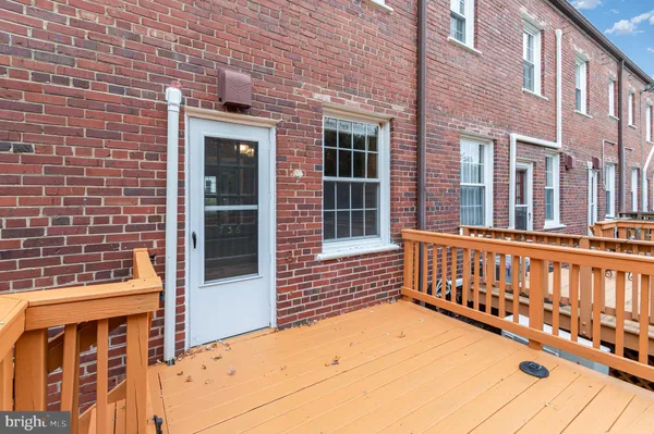 a balcony with wooden floor and trees