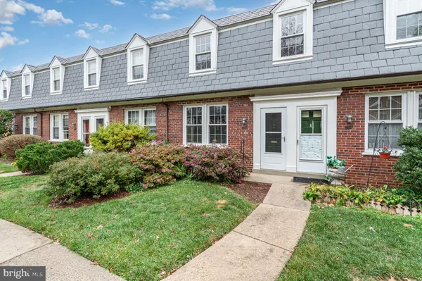 a front view of a house with garden and porch