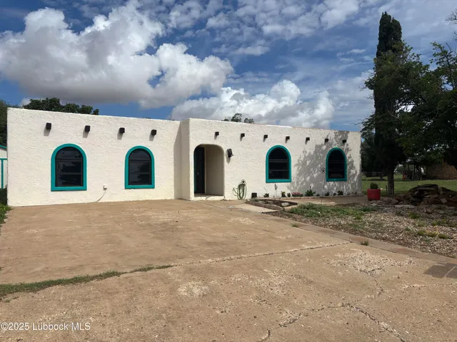 a view of large white house with large windows