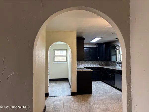 a kitchen with a sink a refrigerator and cabinets