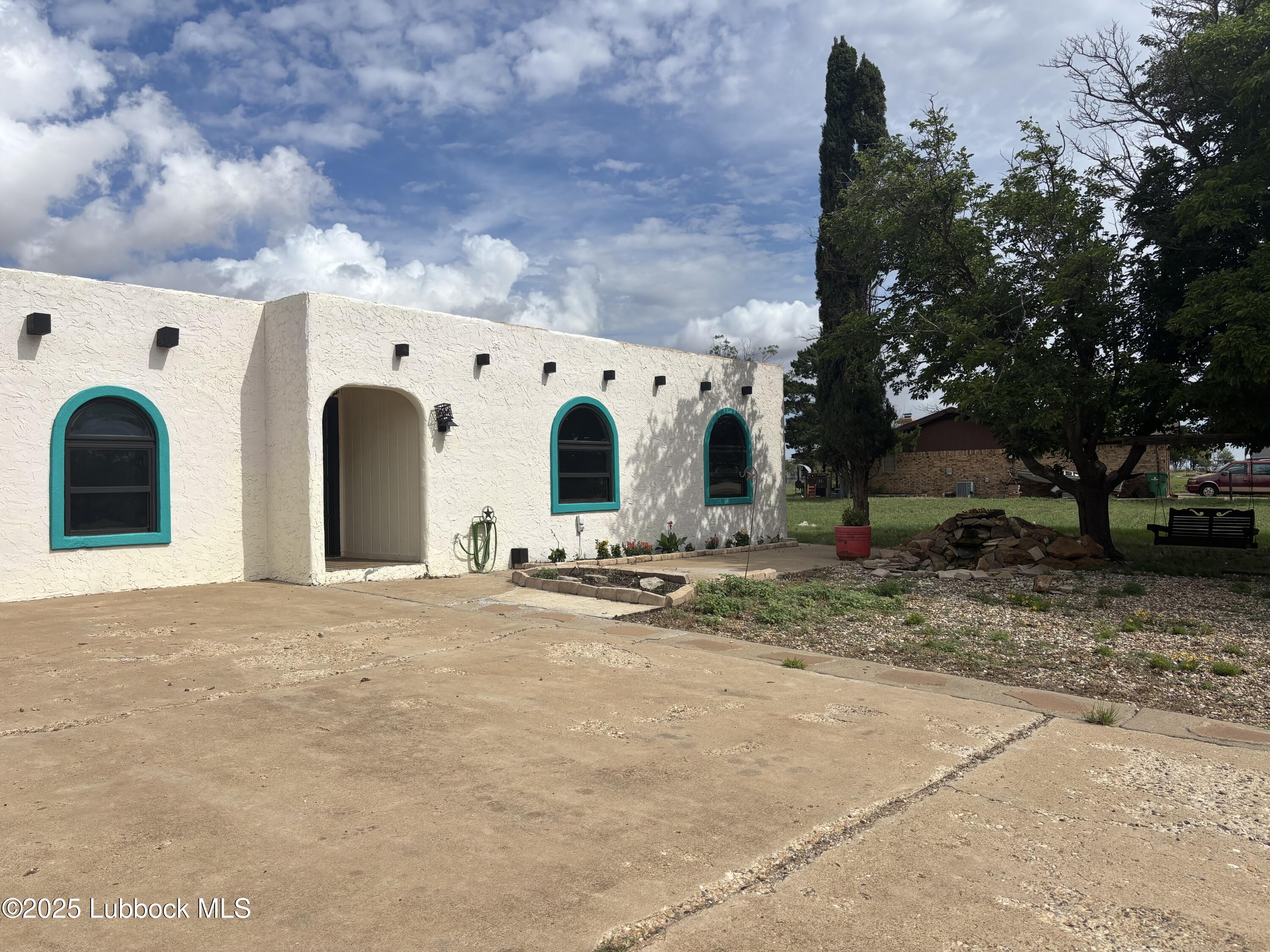 5 Parklane Drive Ransom Canyon, TX 79366 - Photo 2 of 30 a view of a white house with a large space and large trees
