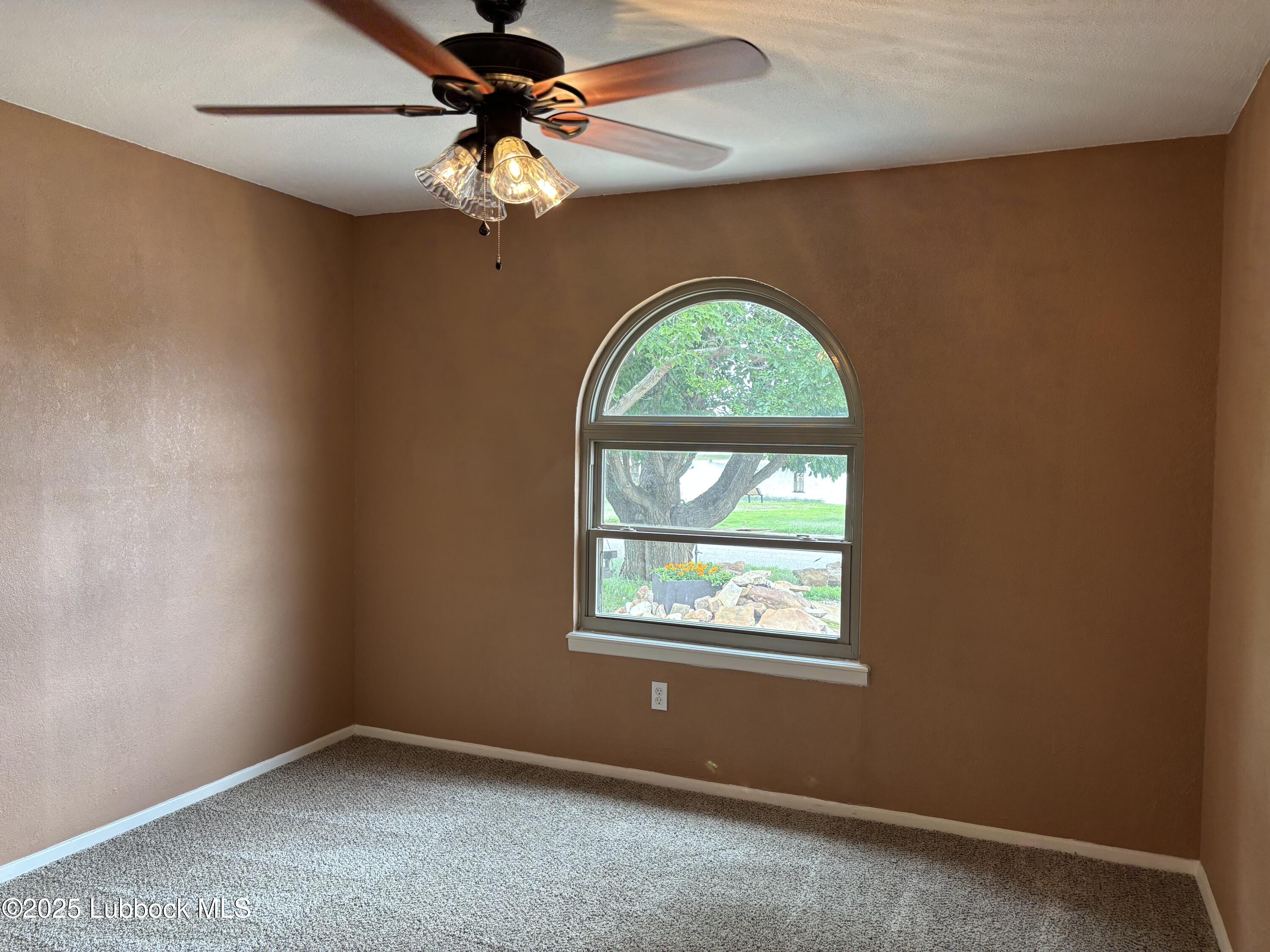 5 Parklane Drive Ransom Canyon, TX 79366 - Photo 26 of 30 an empty room with windows and fan
