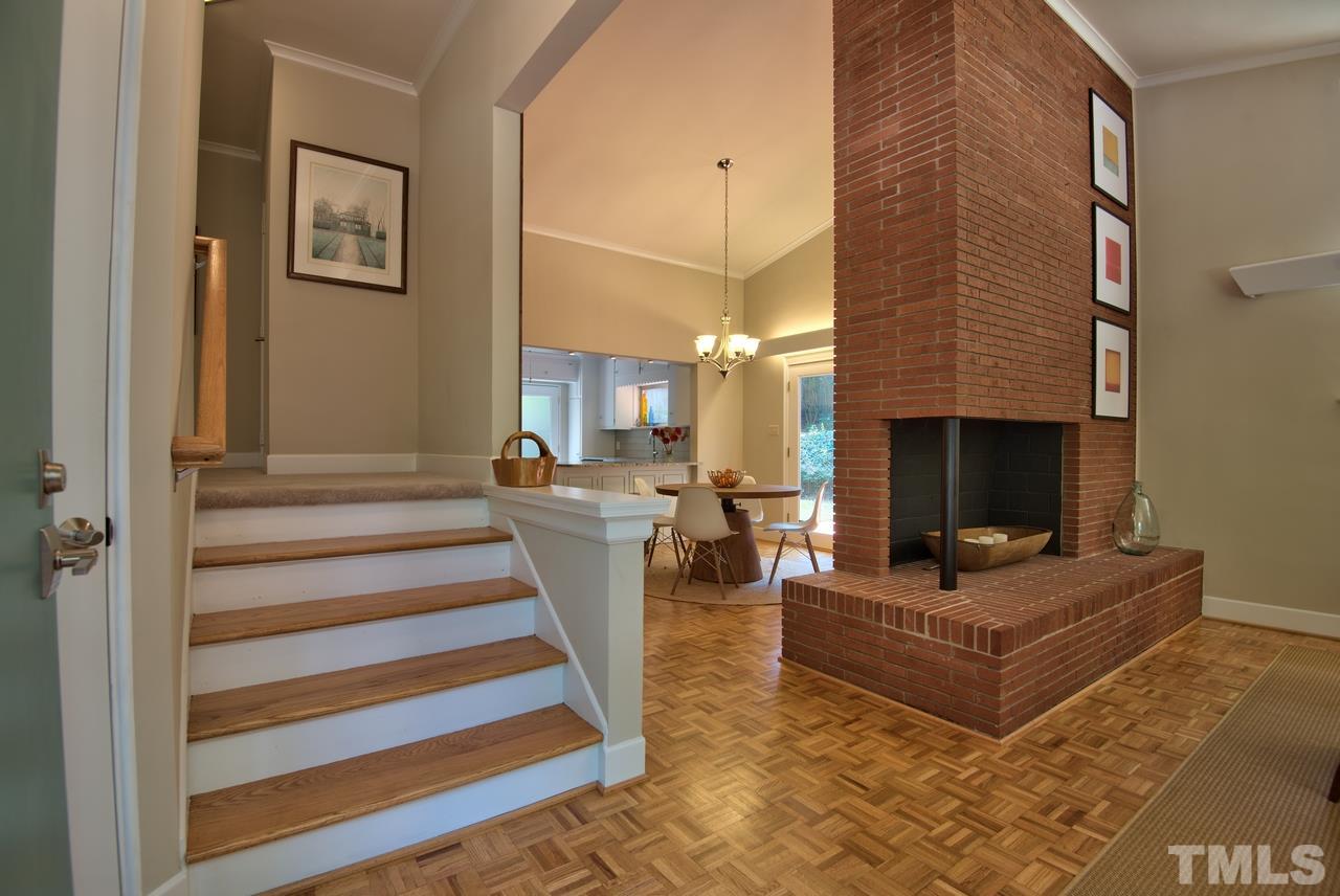 1207 Woodburn Road Durham, NC 27705 - Photo 3 of 25 ...with an exposed brick, REAL wood-burning fireplace. This fireplace wall entry is another Webb design element. It's great to see the bones remain the same after 62 years but to have a home MOVE-IN READY just for you!