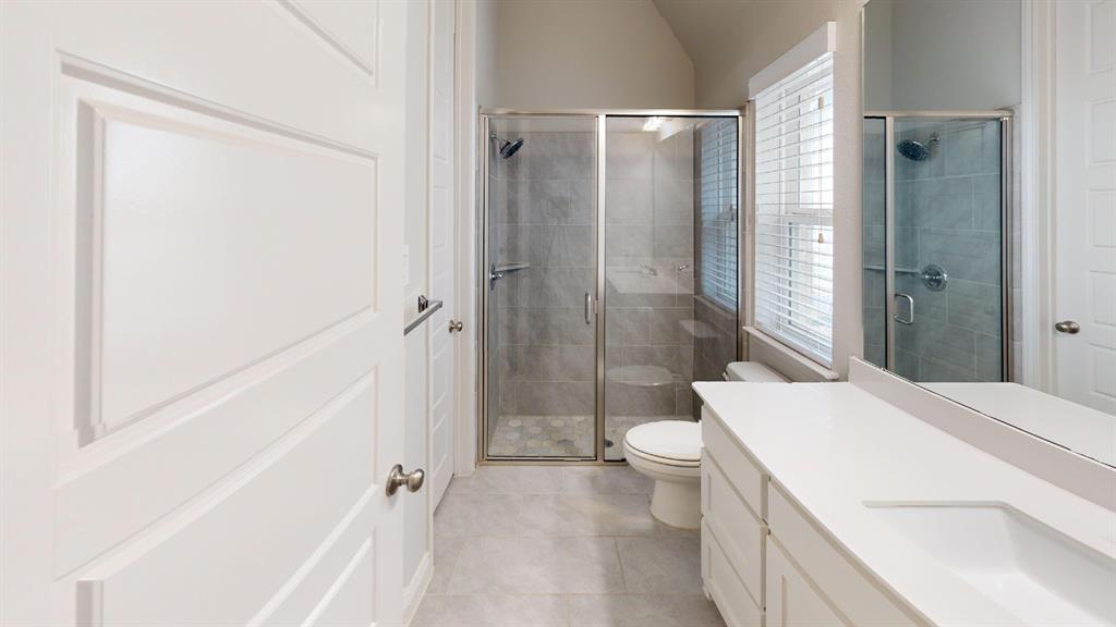 1516 Twistleaf Road Flower Mound, TX 76226 - Photo 17 of 22 a bathroom with a sink a toilet and shower