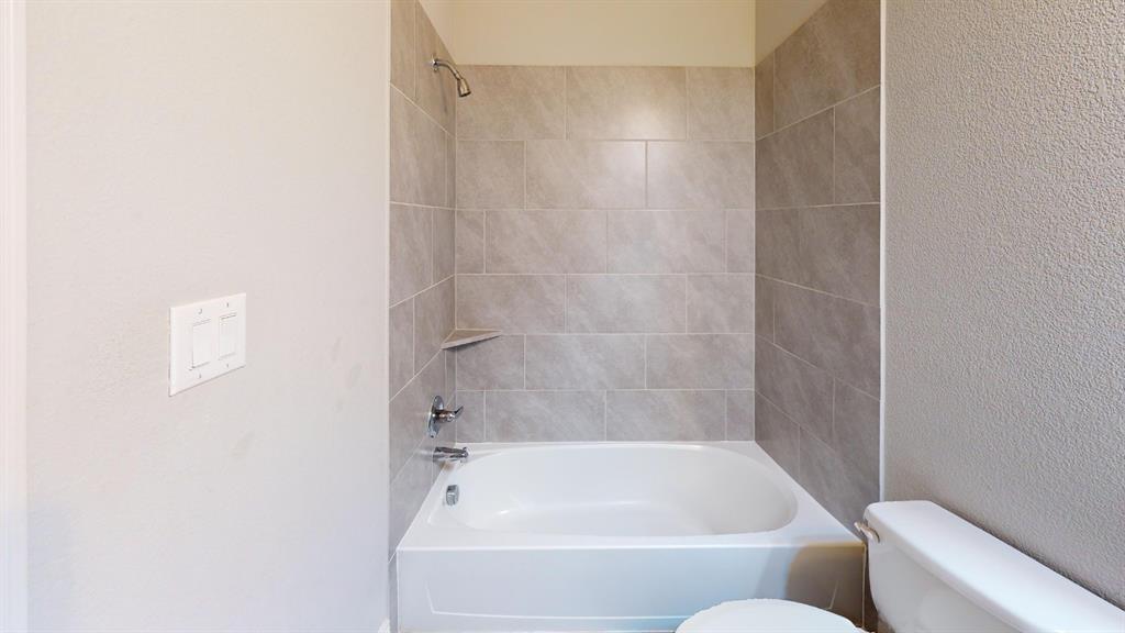 1516 Twistleaf Road Flower Mound, TX 76226 - Photo 19 of 22 a bathroom with a bathtub and shower