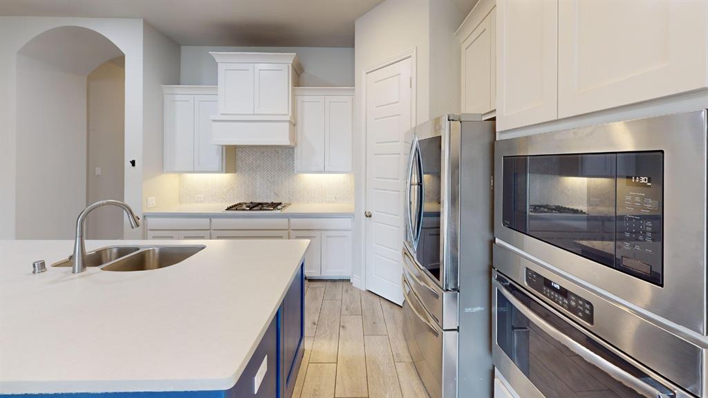 1516 Twistleaf Road Flower Mound, TX 76226 - Photo 5 of 22 a kitchen with a refrigerator and a sink