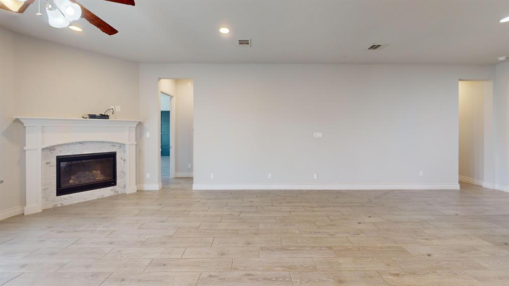 1516 Twistleaf Road Flower Mound, TX 76226 - Photo 6 of 22 a view of an empty room with a fireplace