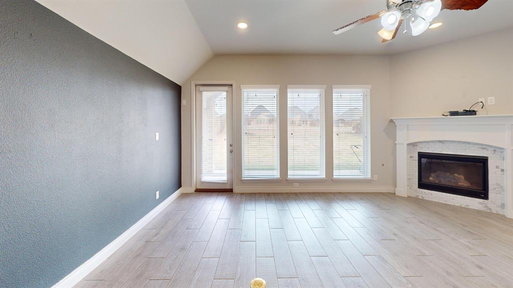 1516 Twistleaf Road Flower Mound, TX 76226 - Photo 7 of 22 a view of an empty room with a window and wooden floor
