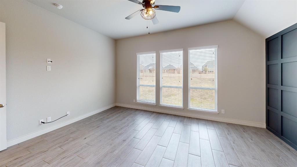 1516 Twistleaf Road Flower Mound, TX 76226 - Photo 10 of 22 an empty room with wooden floor chandelier fan and windows