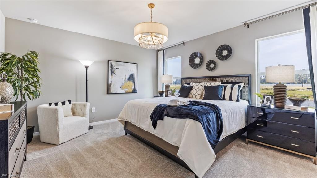 17752 Shade Tree Loop Punta Gorda, FL 33982 - Photo 10 of 40 Model Photo -Bedroom featuring light carpet and baseboards