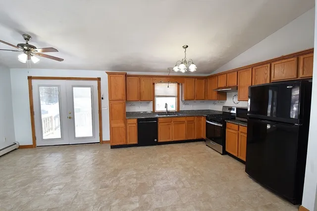 a kitchen with granite countertop stainless steel appliances and wooden cabinets