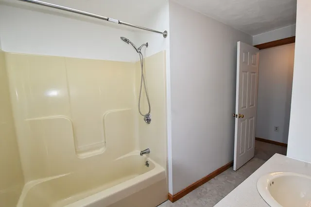 a bathroom with a bathtub and a shower