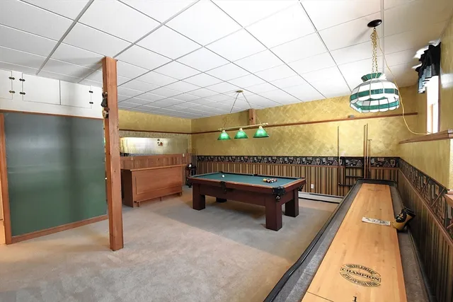 a reading room with furniture and a potted plant