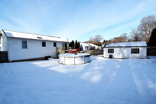 a view of the house with backyard and sitting area