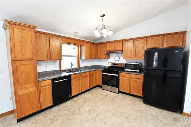 a kitchen with granite countertop stainless steel appliances and wooden cabinets