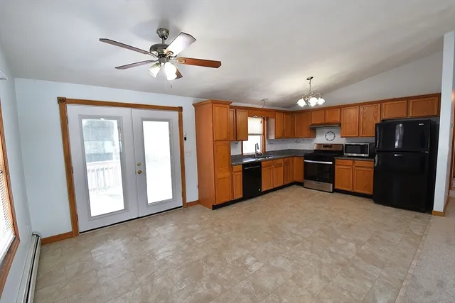 a kitchen with stainless steel appliances granite countertop a refrigerator and a stove top oven