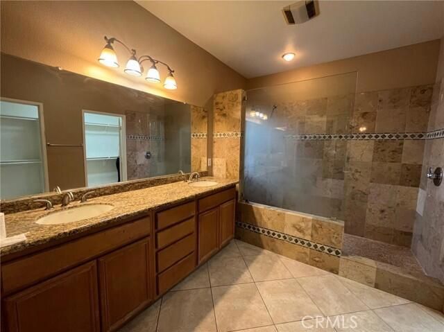 a bathroom with a double vanity sink and a mirror