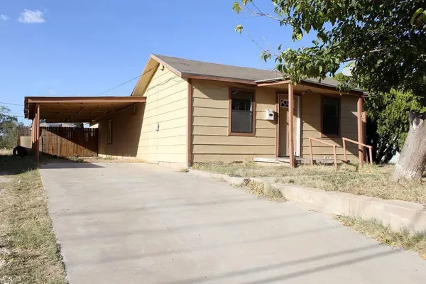 a view of house with backyard and trees