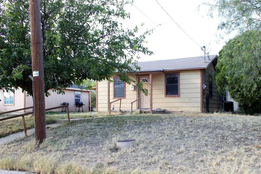 811 East 16th Street Big Spring, TX 79720 - Photo 2 of 20 a house that has a tree in front of the house