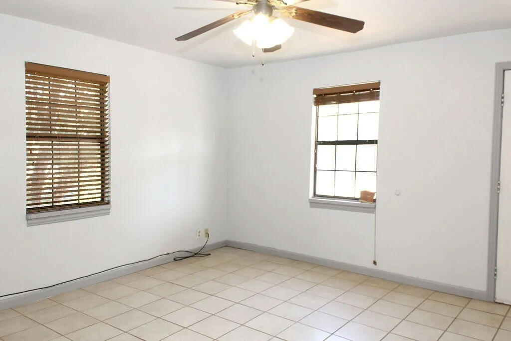 811 East 16th Street Big Spring, TX 79720 - Photo 5 of 20 an empty room with windows