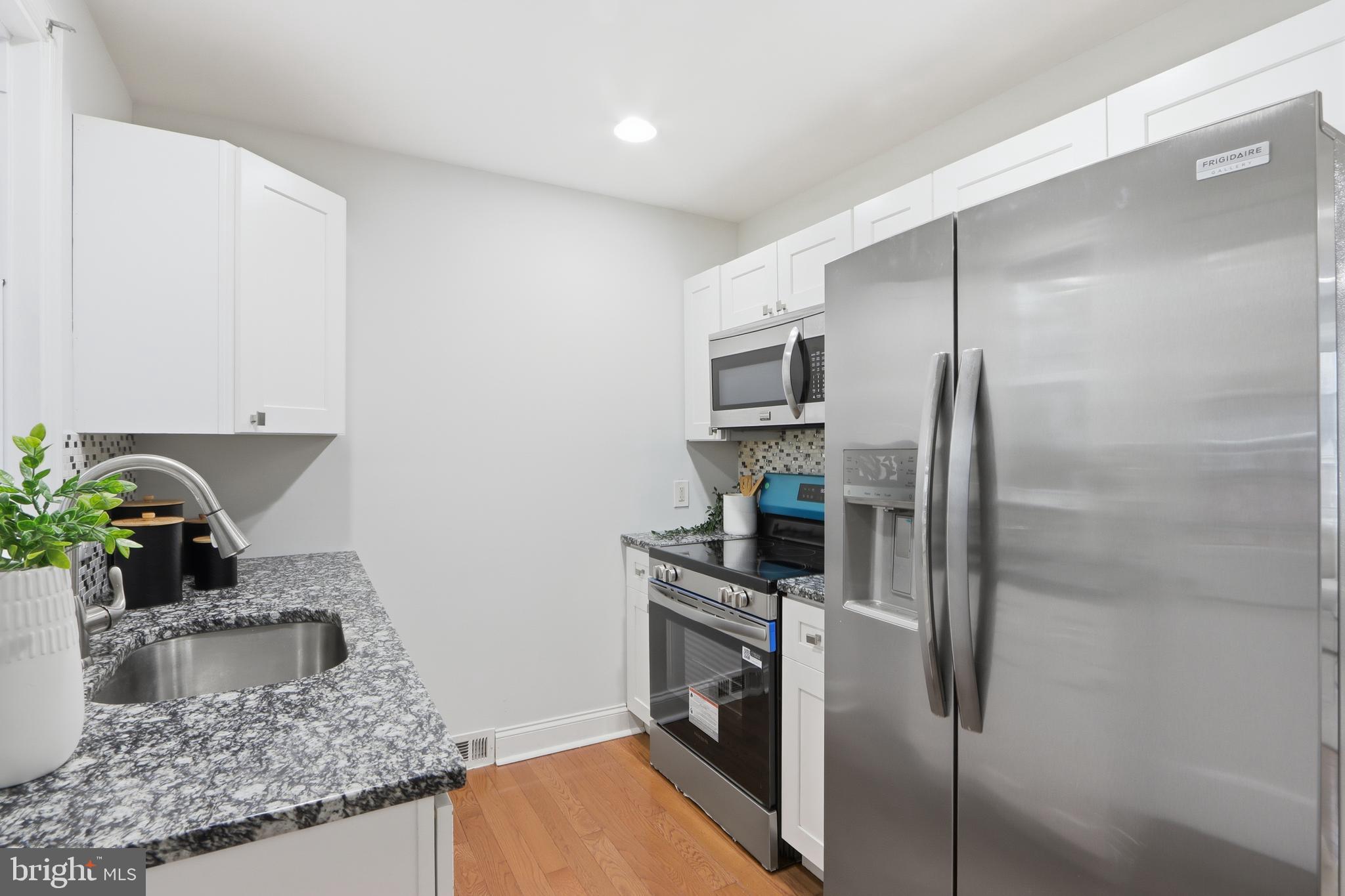 3497 Hillsmere Road Gwynn Oak, MD 21207 - Photo 12 of 45 a kitchen with stainless steel appliances granite countertop a refrigerator and a sink