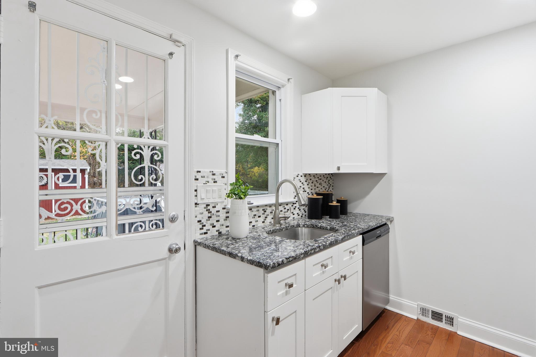 3497 Hillsmere Road Gwynn Oak, MD 21207 - Photo 13 of 45 a kitchen with stainless steel appliances granite countertop a sink and a white cabinets