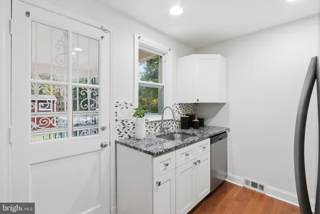 a kitchen with stainless steel appliances granite countertop a refrigerator and a sink