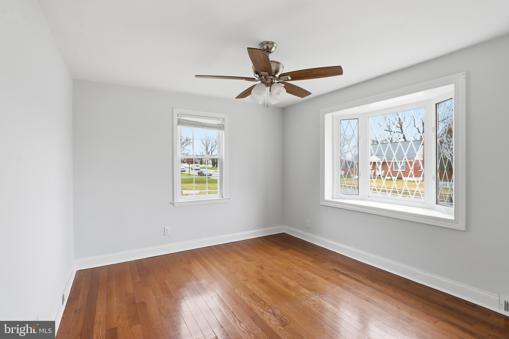 3497 Hillsmere Road Gwynn Oak, MD 21207 - Photo 16 of 45 a view of an empty room with a window and wooden floor
