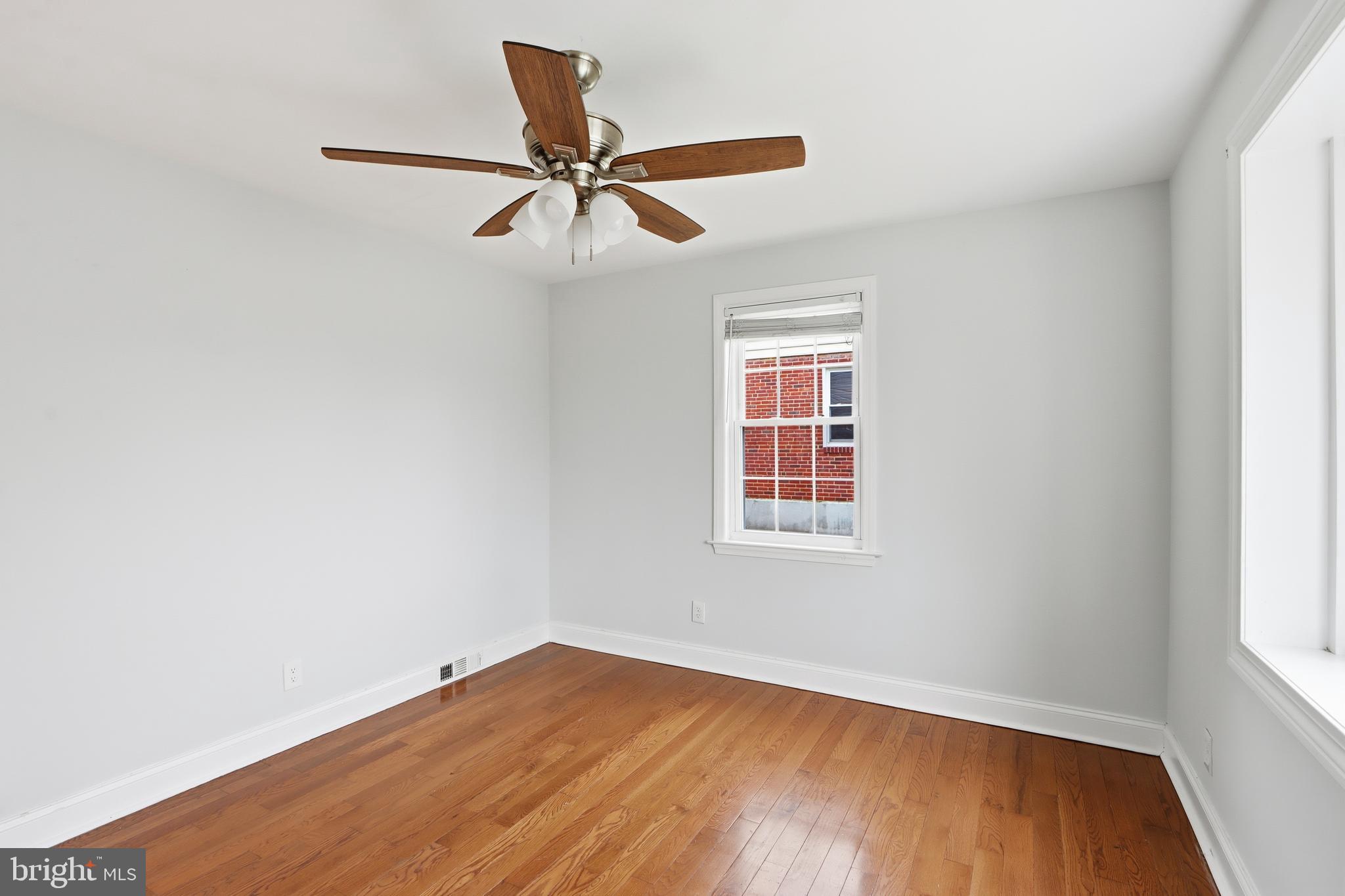 3497 Hillsmere Road Gwynn Oak, MD 21207 - Photo 17 of 45 an empty room with wooden floor fan and windows