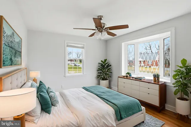 a bedroom with a bed and a large window