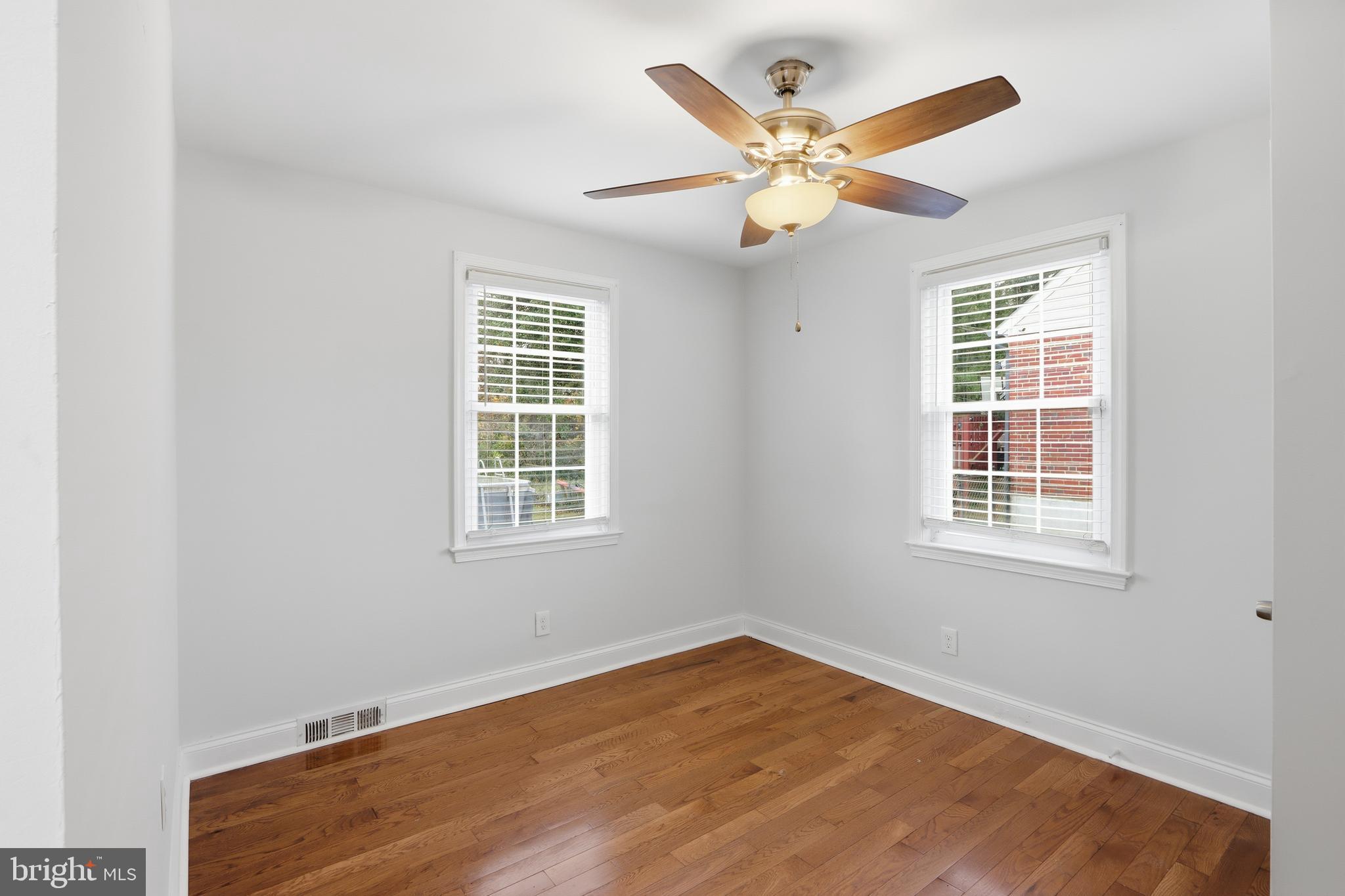 3497 Hillsmere Road Gwynn Oak, MD 21207 - Photo 21 of 45 a view of an empty room with wooden floor and a window