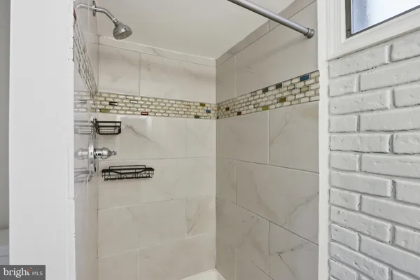a utility room with refrigerator and washer