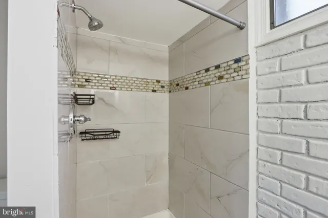 a utility room with refrigerator and washer