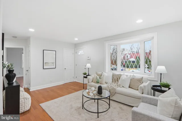 a living room with furniture a rug and a window