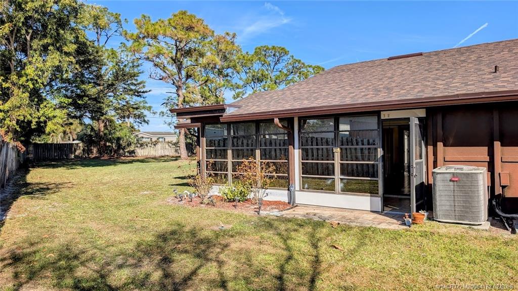 6531 Southeast Federal Highway, Unit A109 Stuart, FL 34997 - Photo 15 of 21 a view of a house with a large tree and a yard