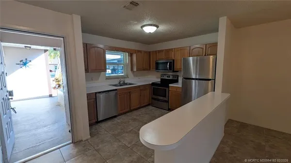 a kitchen with stainless steel appliances a refrigerator and a stove top oven