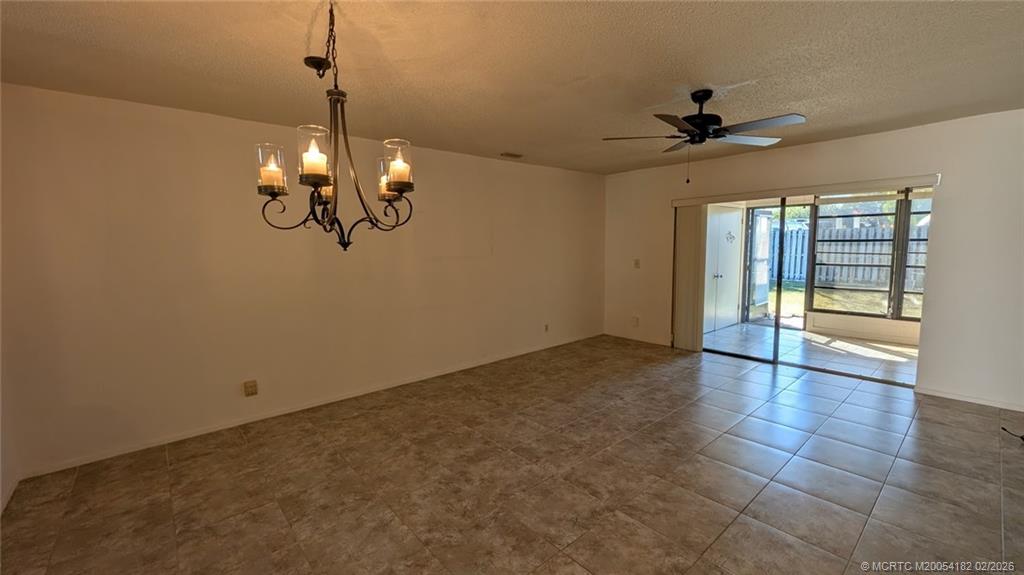 6531 Southeast Federal Highway, Unit A109 Stuart, FL 34997 - Photo 4 of 21 a view of a livingroom with a chandelier fan and windows