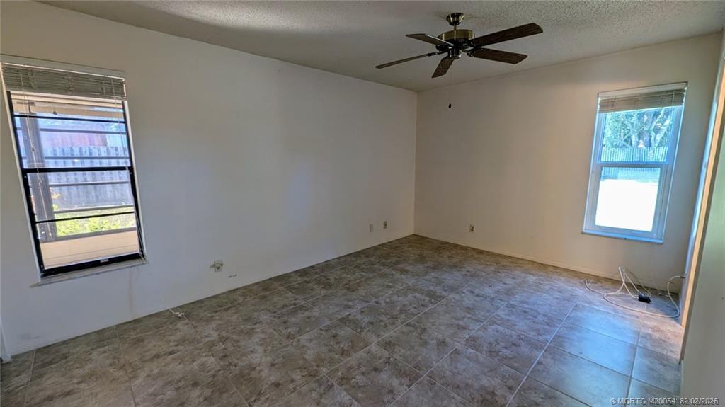 6531 Southeast Federal Highway, Unit A109 Stuart, FL 34997 - Photo 7 of 21 a view of a room with a ceiling fan and a window