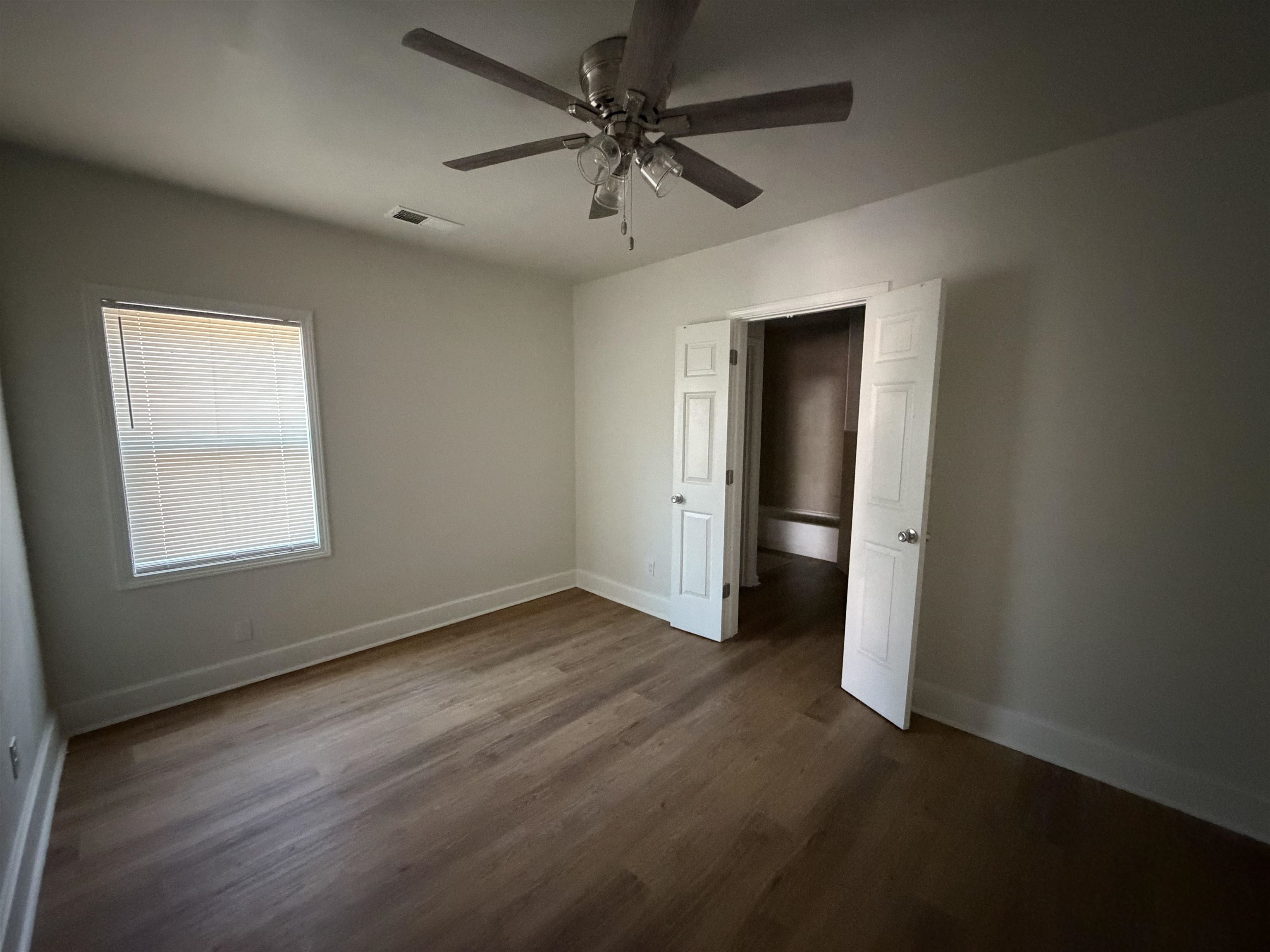 3739 Rhea Avenue Memphis, TN 38122 - Photo 5 of 10 an empty room with a window and a ceiling fan